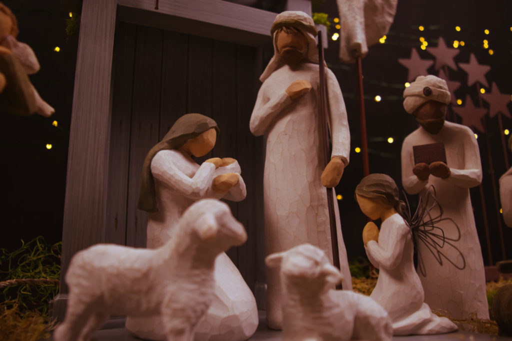 nativity set with baby Jesus, Mary, Joseph, a wise man, and sheep