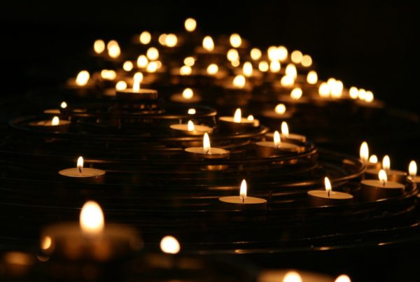 A number of candles lighting up the darkness