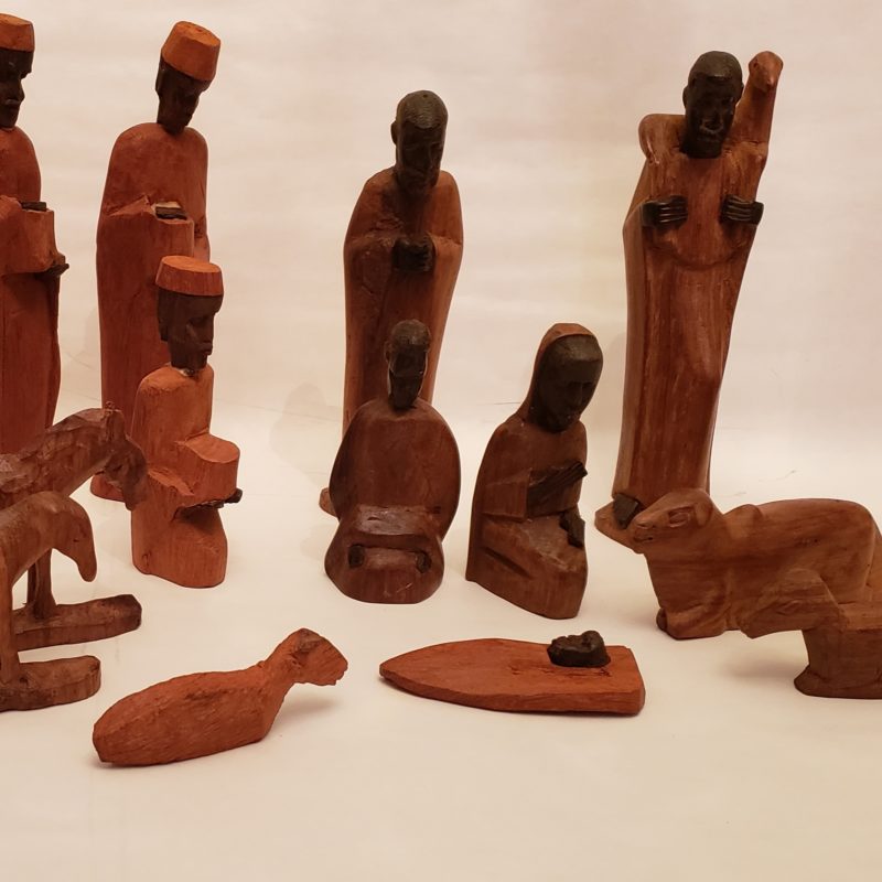 A wooden, African-style nativity against a white background
