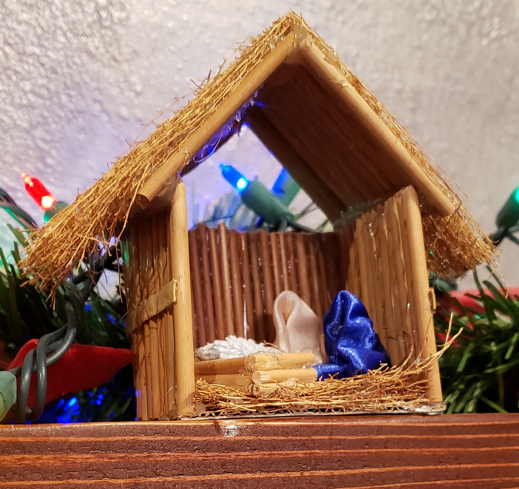 A simple nativity and manger made out of straw