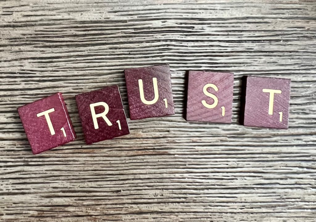 scrabble tiles spelling out "trust"