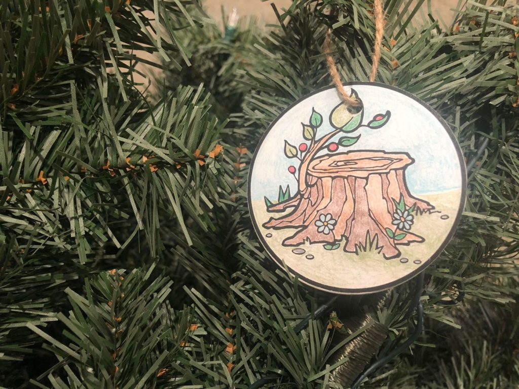 Jesse Tree ornament for the first day of Advent hanging on a Christmas tree