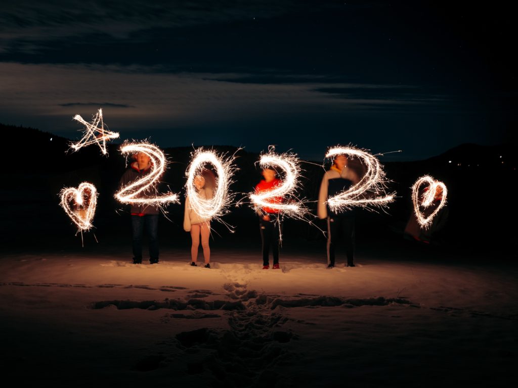 2022 numbers written by sparklers against night sky