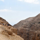travelers walk along the dry, dusty Jericho Road