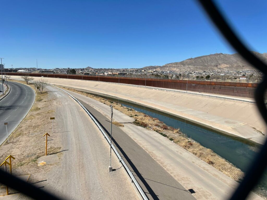 U.S. - Mexico border as seen through a fence